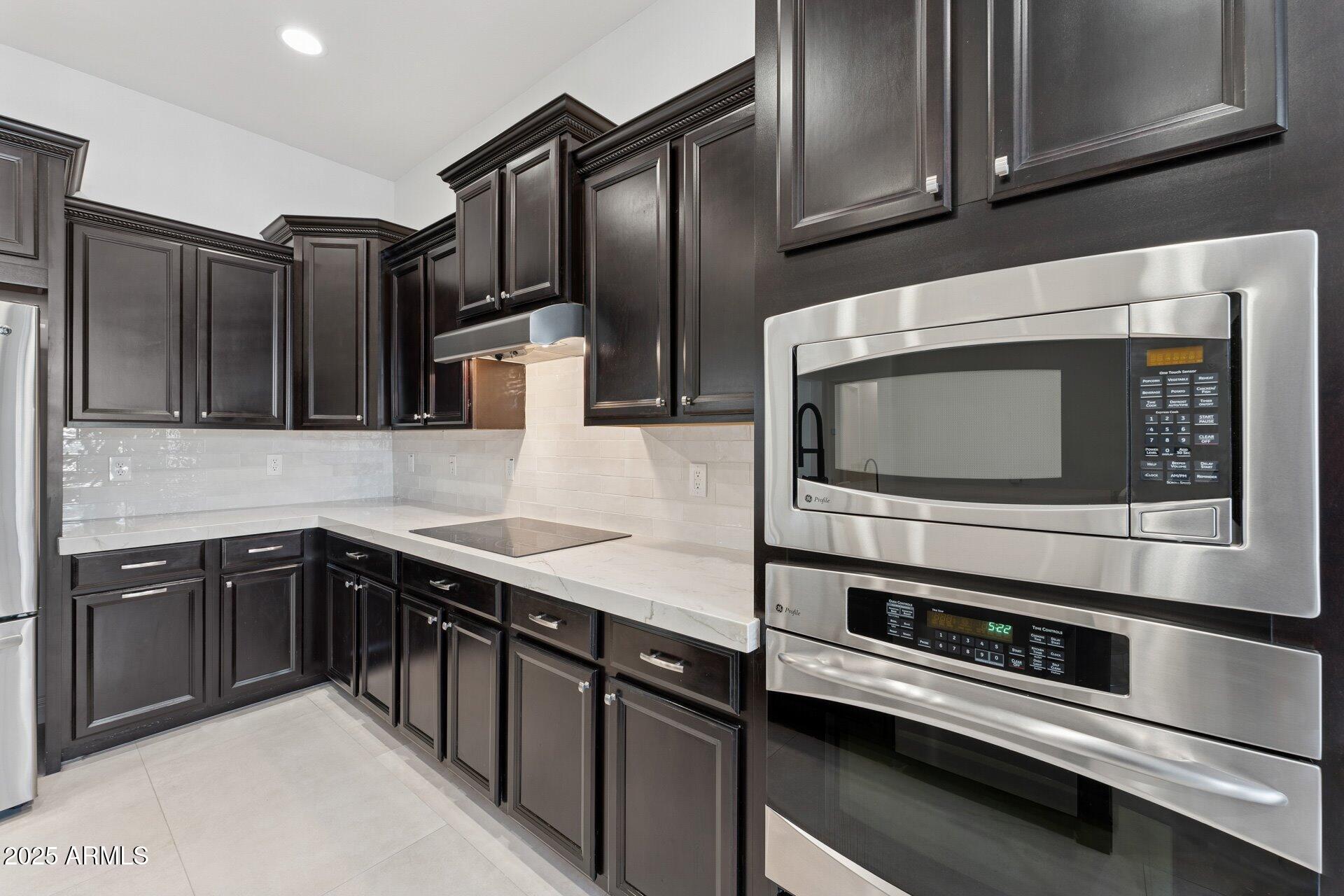 4547 South Banning Drive Gilbert, AZ 85297 - Photo 22 of 45 a kitchen with stainless steel appliances and cabinets