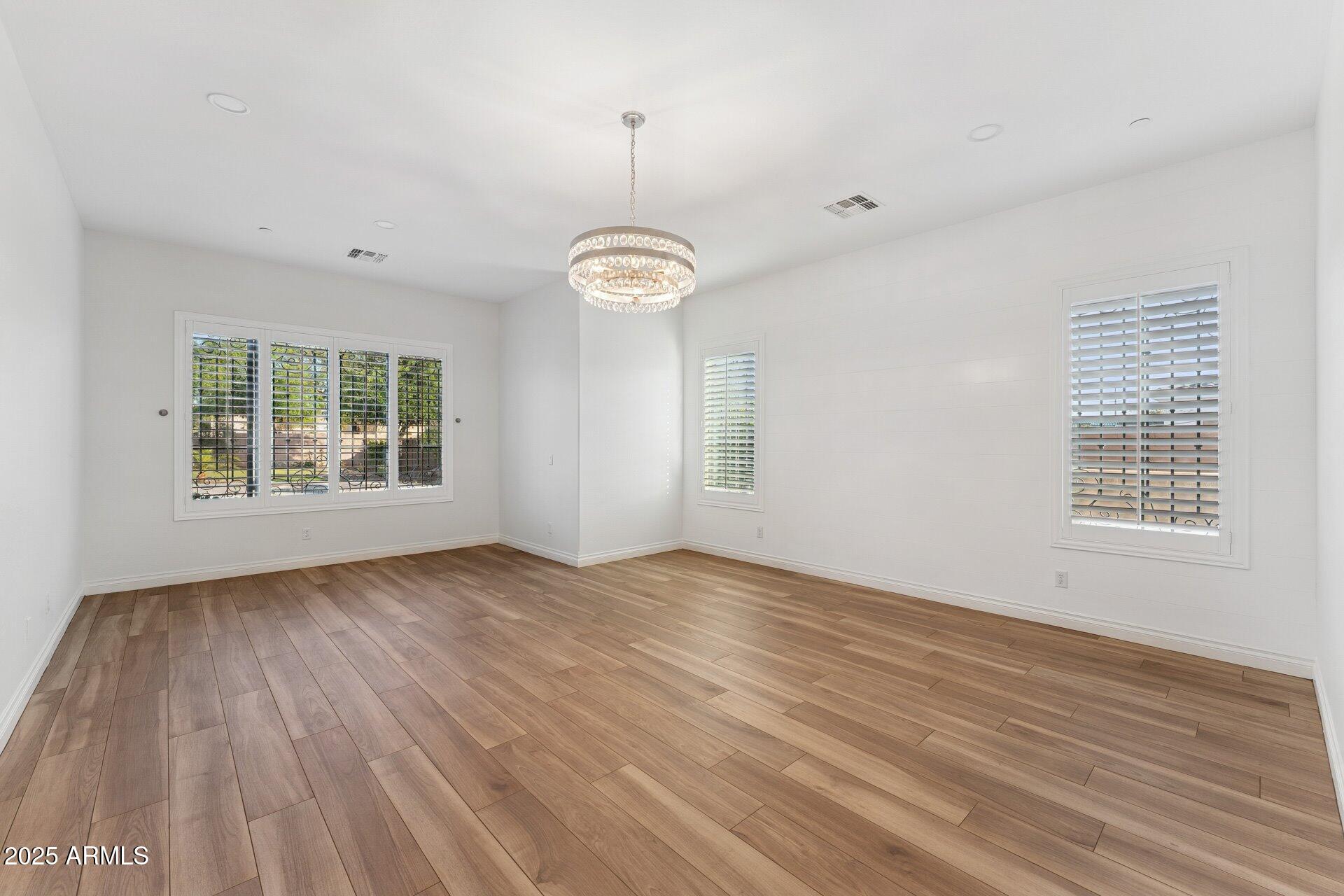 4547 South Banning Drive Gilbert, AZ 85297 - Photo 28 of 45 an empty room with wooden floor and windows