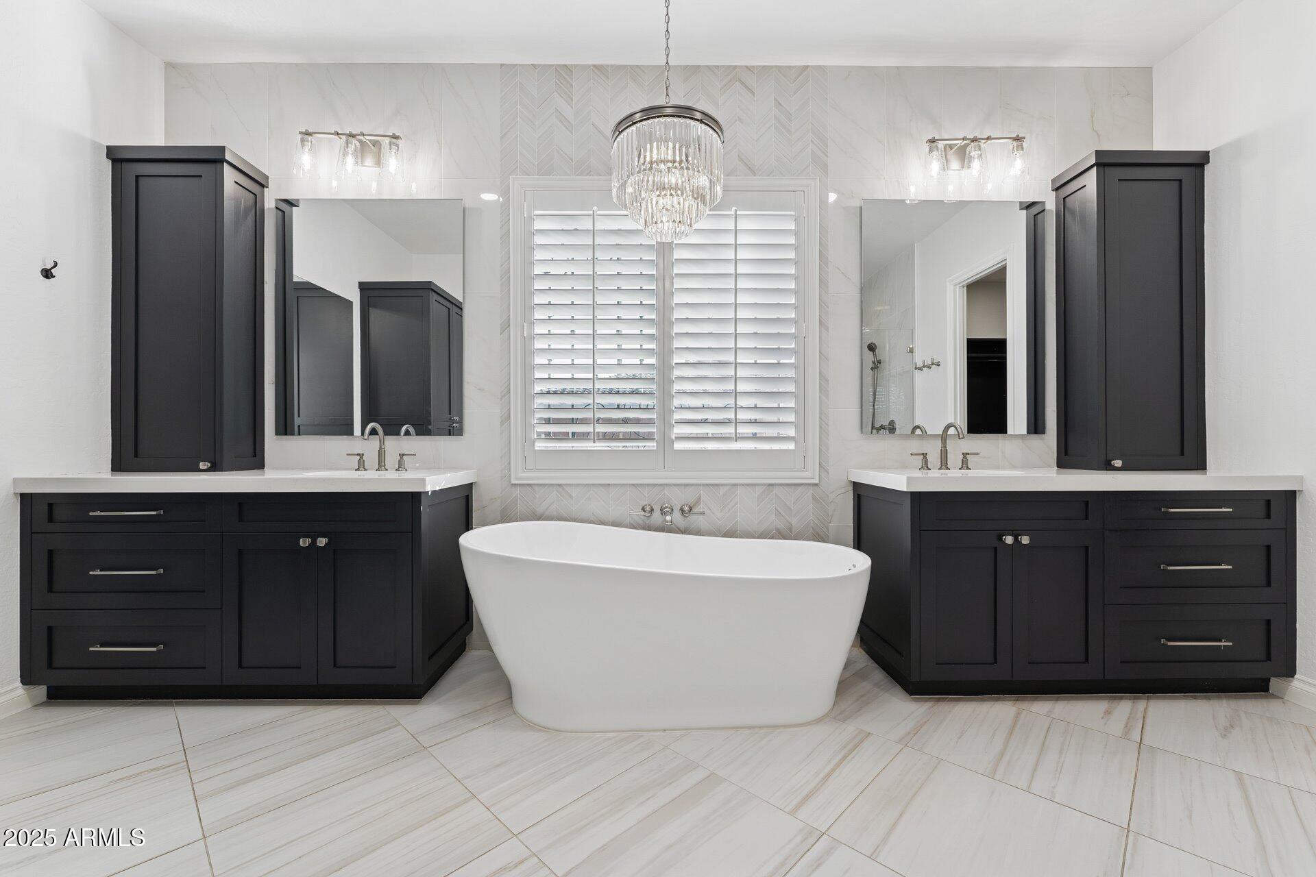 4547 South Banning Drive Gilbert, AZ 85297 - Photo 29 of 45 a spacious bathroom with a tub sink and mirror