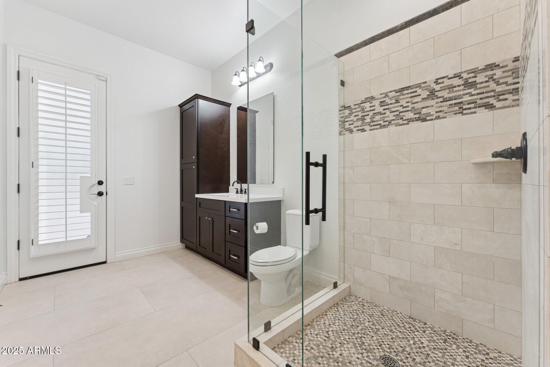 4547 South Banning Drive Gilbert, AZ 85297 - Photo 33 of 45 a spacious bathroom with a toilet a sink and shower