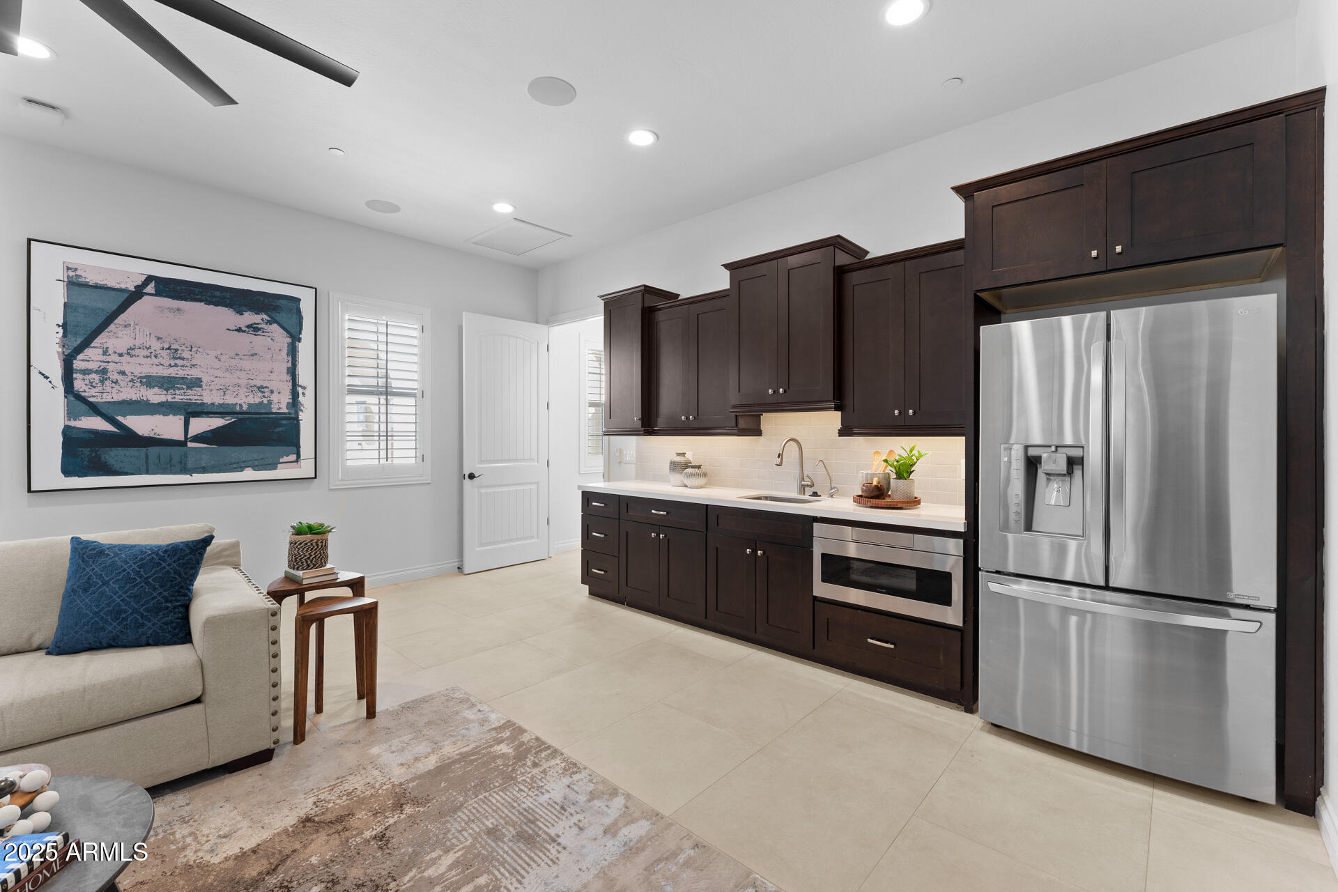 4547 South Banning Drive Gilbert, AZ 85297 - Photo 38 of 45 a kitchen with stainless steel appliances kitchen island granite countertop a refrigerator and a stove top oven