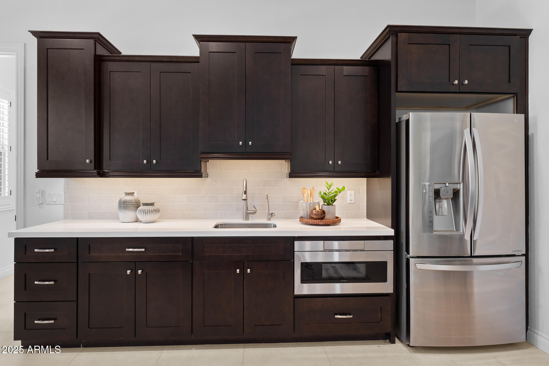 4547 South Banning Drive Gilbert, AZ 85297 - Photo 39 of 45 a kitchen with a sink and a refrigerator