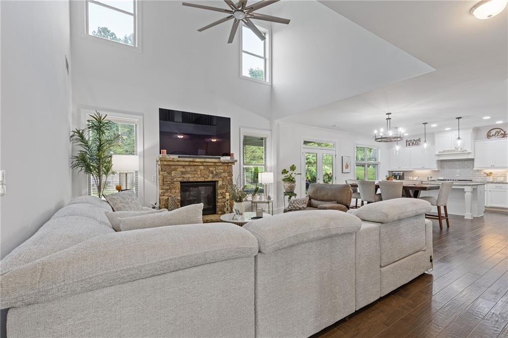 4867 Hunters Grove Way Sugar Hill, GA 30518 - Photo 13 of 61 a living room with furniture a fireplace and a flat screen tv