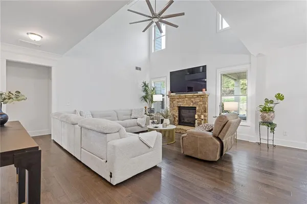 a living room with furniture and a wooden floor