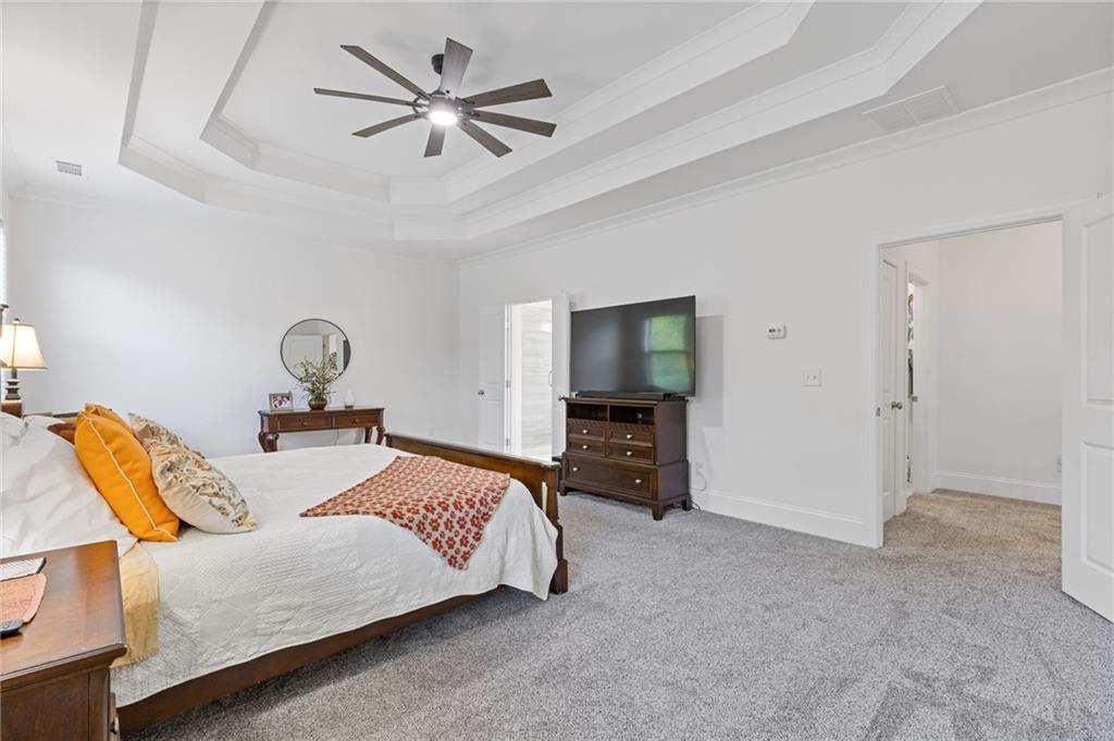 4867 Hunters Grove Way Sugar Hill, GA 30518 - Photo 31 of 61 a bedroom with a bed and a television