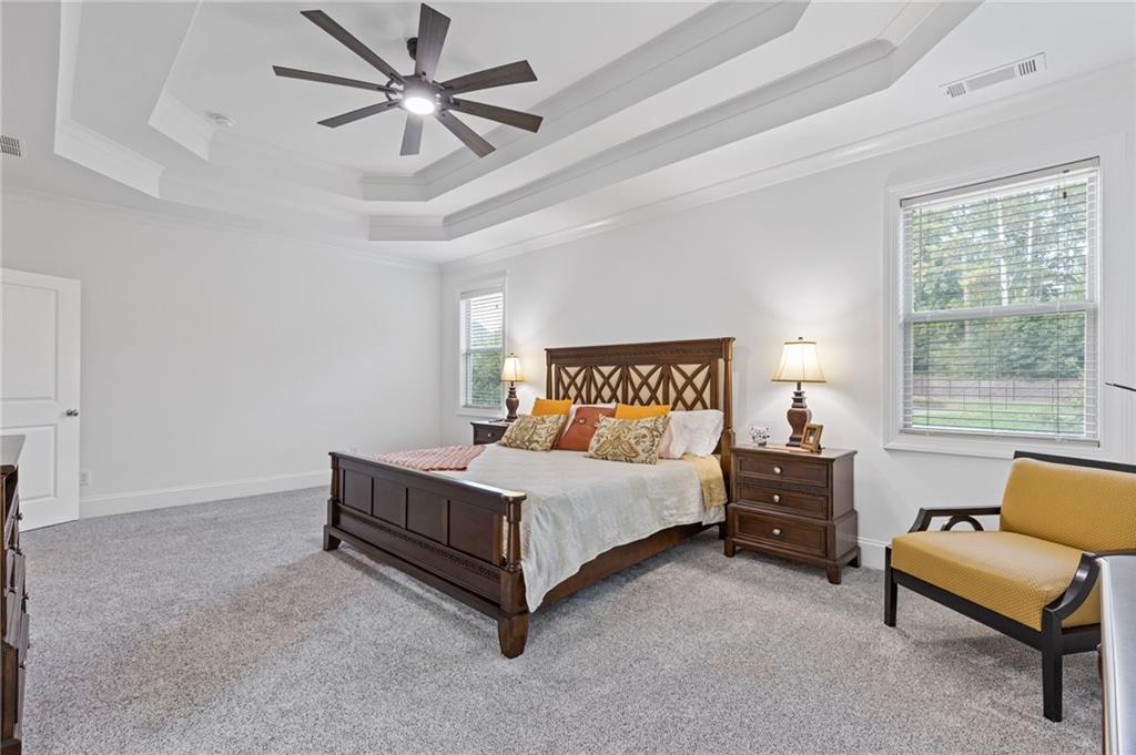 4867 Hunters Grove Way Sugar Hill, GA 30518 - Photo 32 of 61 a bedroom with a bed and a couch