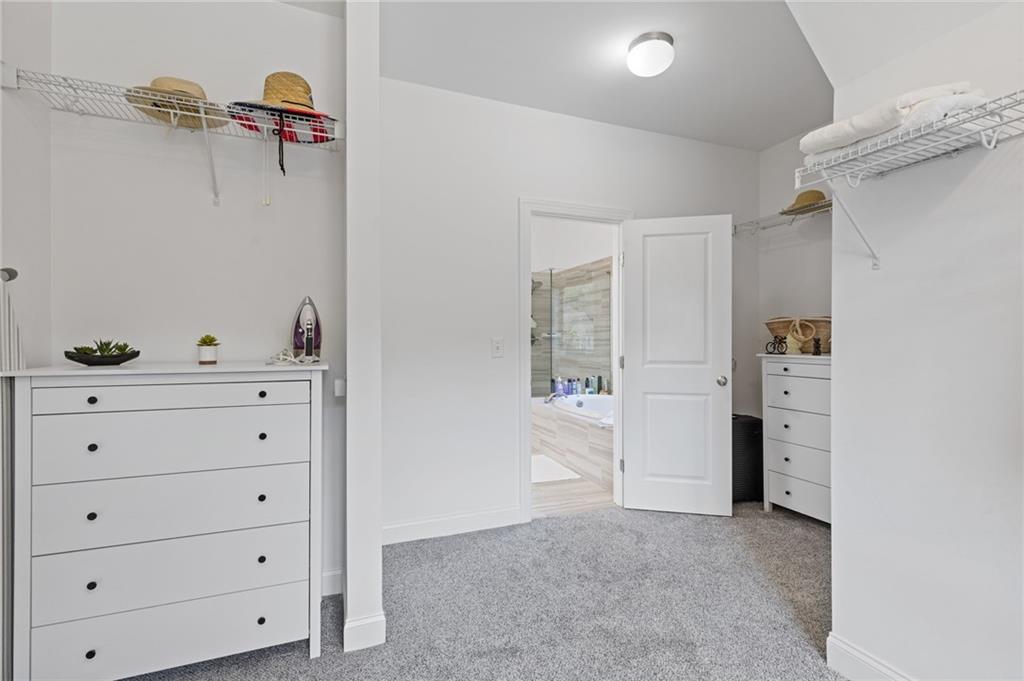 4867 Hunters Grove Way Sugar Hill, GA 30518 - Photo 37 of 61 a view of an empty walk in closet