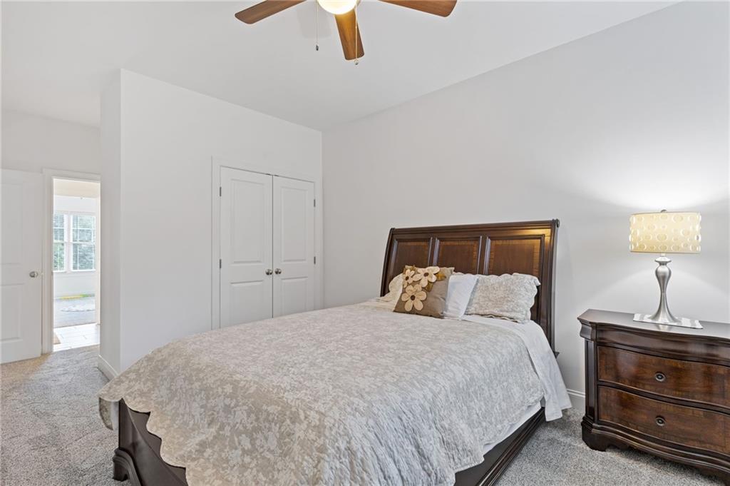 4867 Hunters Grove Way Sugar Hill, GA 30518 - Photo 42 of 61 a bedroom with a bed and dresser