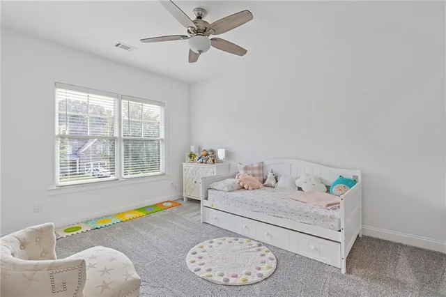 a view of a house with backyard and trees