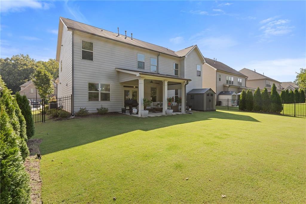 4867 Hunters Grove Way Sugar Hill, GA 30518 - Photo 52 of 61 a view of a house with a backyard