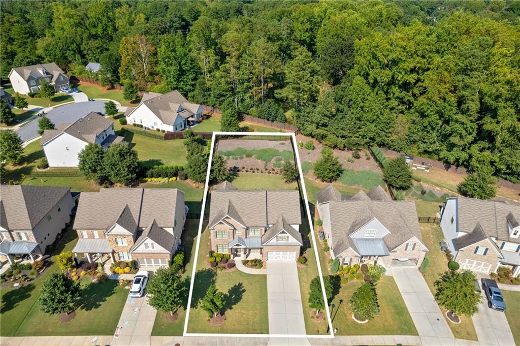 4867 Hunters Grove Way Sugar Hill, GA 30518 - Photo 58 of 61 an aerial view of a house with a yard basket ball court and outdoor seating