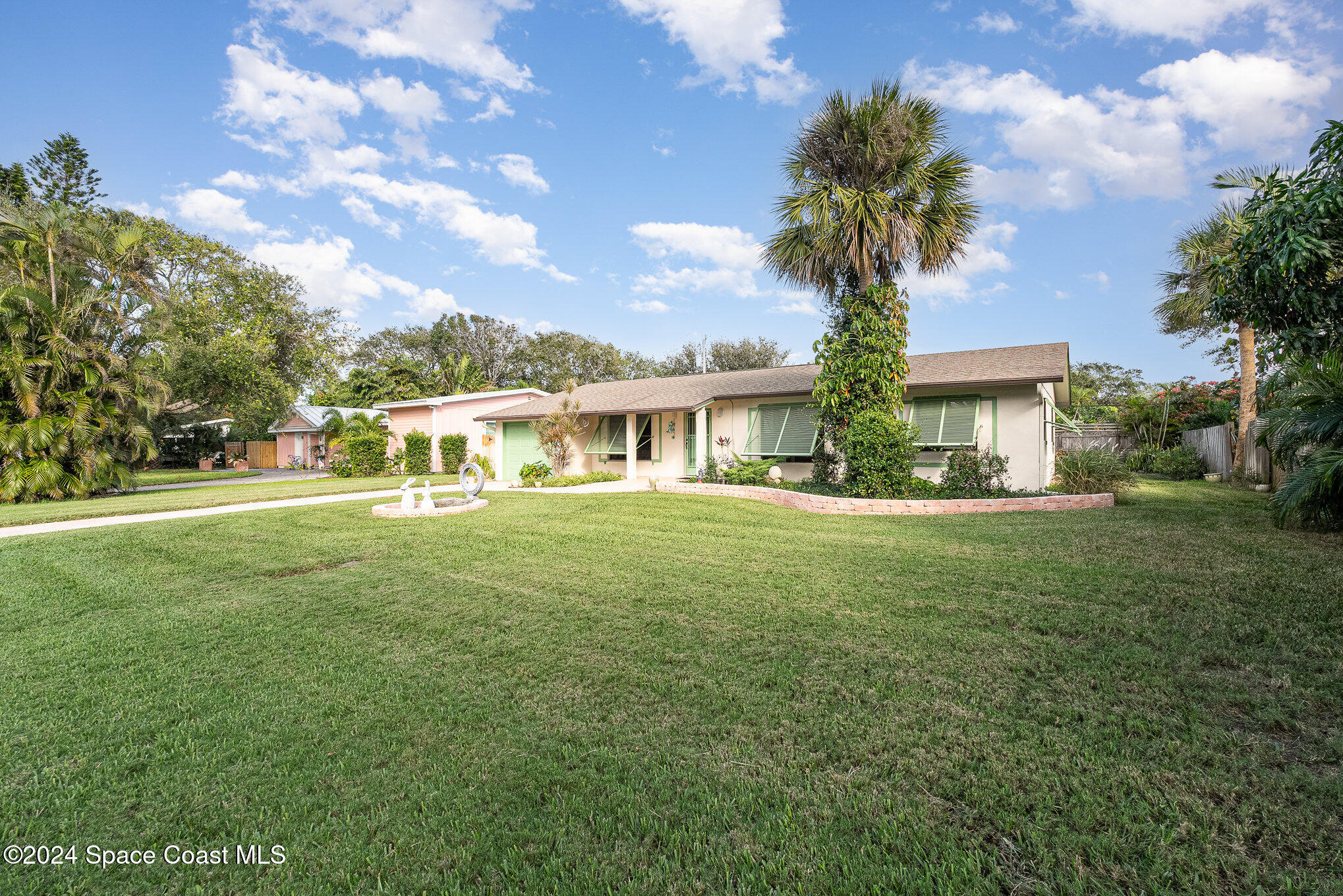 968 Trinidad Road Cocoa Beach, FL 32931 - Photo 18 of 20 a front view of a house with garden