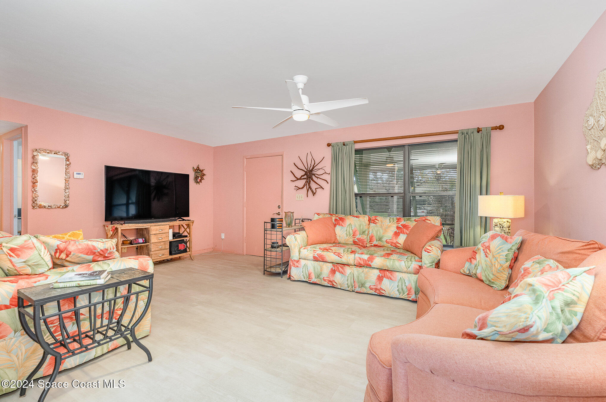968 Trinidad Road Cocoa Beach, FL 32931 - Photo 4 of 20 a living room with furniture and a flat screen tv