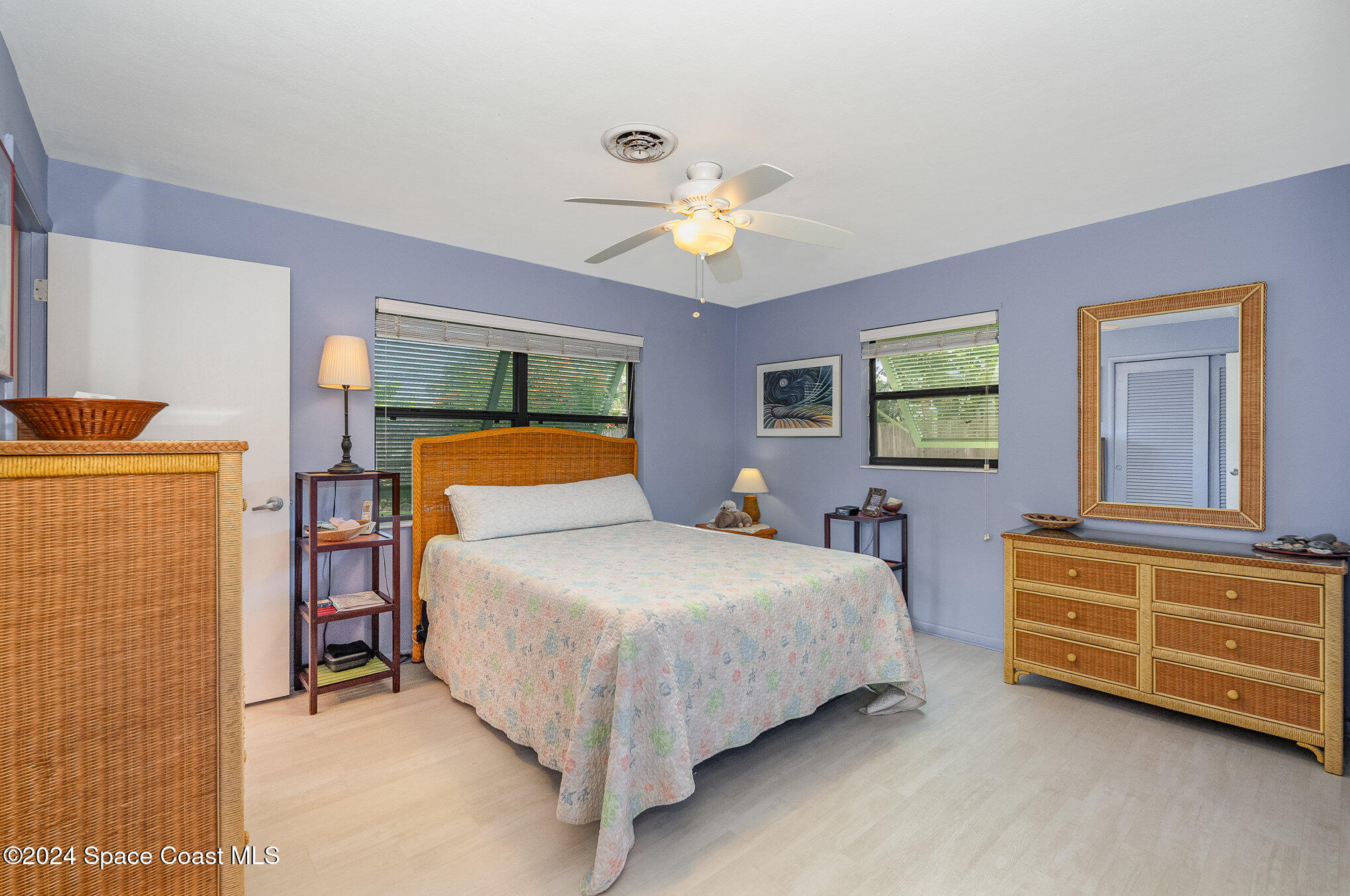 968 Trinidad Road Cocoa Beach, FL 32931 - Photo 10 of 20 a bedroom with a bed and a chandelier