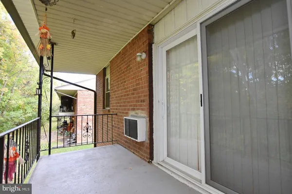 a view of a porch with wooden floor and stairs