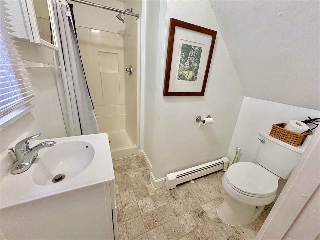 285 Roxbury Street Boston, MA 02119 - Photo 5 of 15 a white toilet sitting next to a bathroom sink