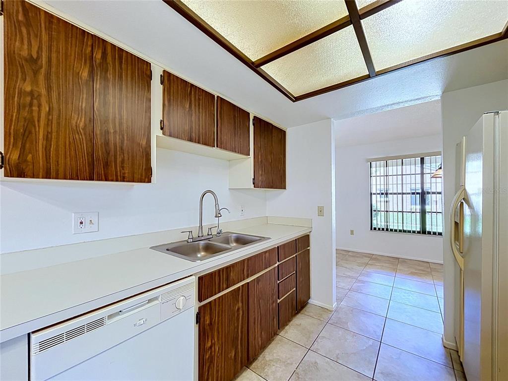 9319 Trowbridge Court New Port Richey, FL 34655 - Photo 32 of 78 a kitchen with a sink stove and cabinets
