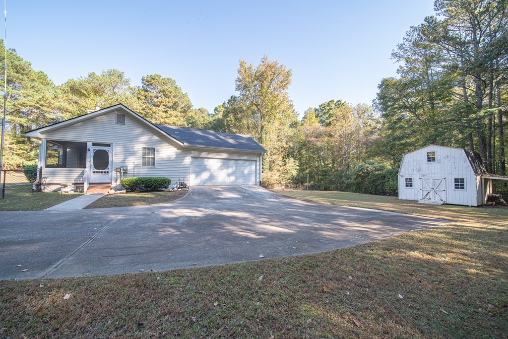 200 Lake Amah Lee Road Hampton, GA 30228 - Photo 27 of 29 a view of a house with a yard and large tree