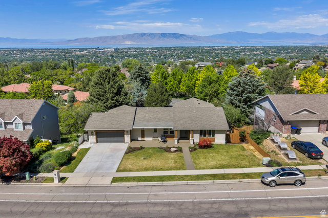 3813 North Foothill Drive Provo, UT 84604 - Photo 70 of 71 Ranch-style residence featuring a prominent shingled roof, an attached two-car garage, and a concrete driveway