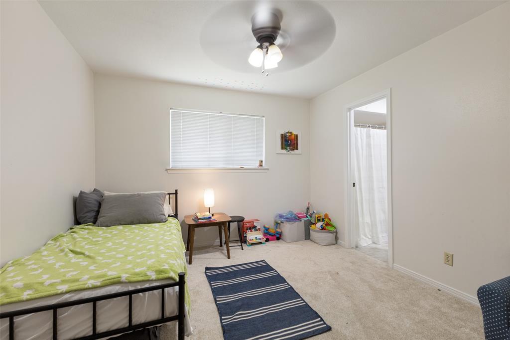 705 South Grove Road Richardson, TX 75081 - Photo 22 of 26 Carpeted room featuring a ceiling fan with integrated lighting, a window with blinds, and an entryway to another space