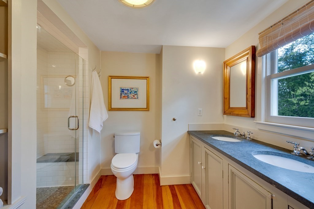 742 Barretts Mill Road Concord, MA 01742 - Photo 19 of 38 a bathroom with a toilet sink a mirror and a shower