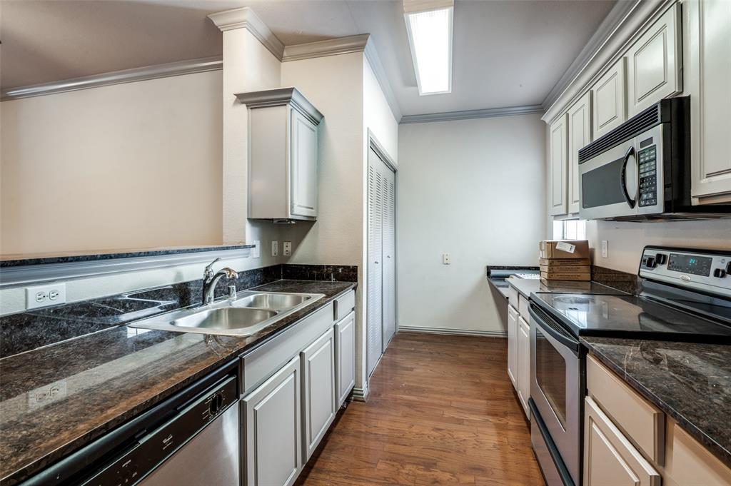 2524 Preston Road, Unit 1404 Plano, TX 75093 - Photo 7 of 15 a kitchen with stainless steel appliances granite countertop a sink stove and cabinets