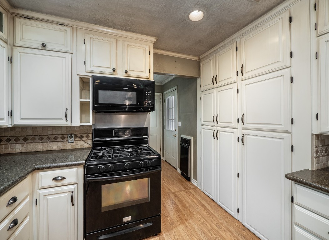 1350 County Road 414 Hamilton, TX 76531 - Photo 11 of 40 a kitchen with white cabinets and white appliances