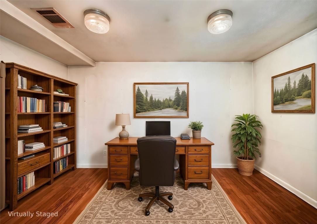 1350 County Road 414 Hamilton, TX 76531 - Photo 16 of 40 a workspace with furniture bookshelf and a wooden floor