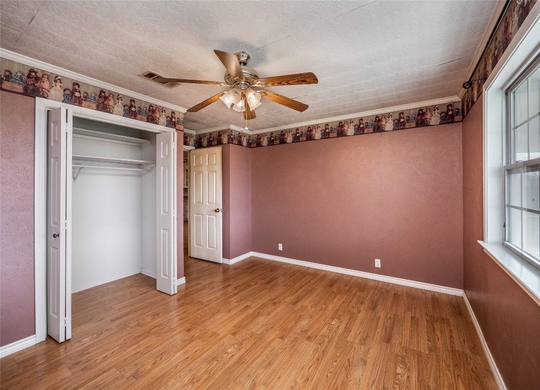 1350 County Road 414 Hamilton, TX 76531 - Photo 19 of 40 a view of room with hardwood floor and window