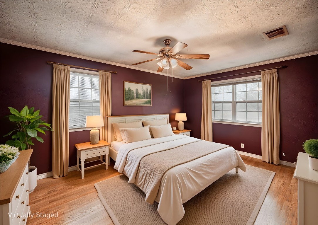 1350 County Road 414 Hamilton, TX 76531 - Photo 20 of 40 a bedroom with a large bed and a chandelier