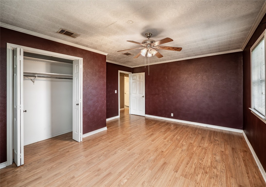 1350 County Road 414 Hamilton, TX 76531 - Photo 21 of 40 a view of an empty room with wooden floor and a window