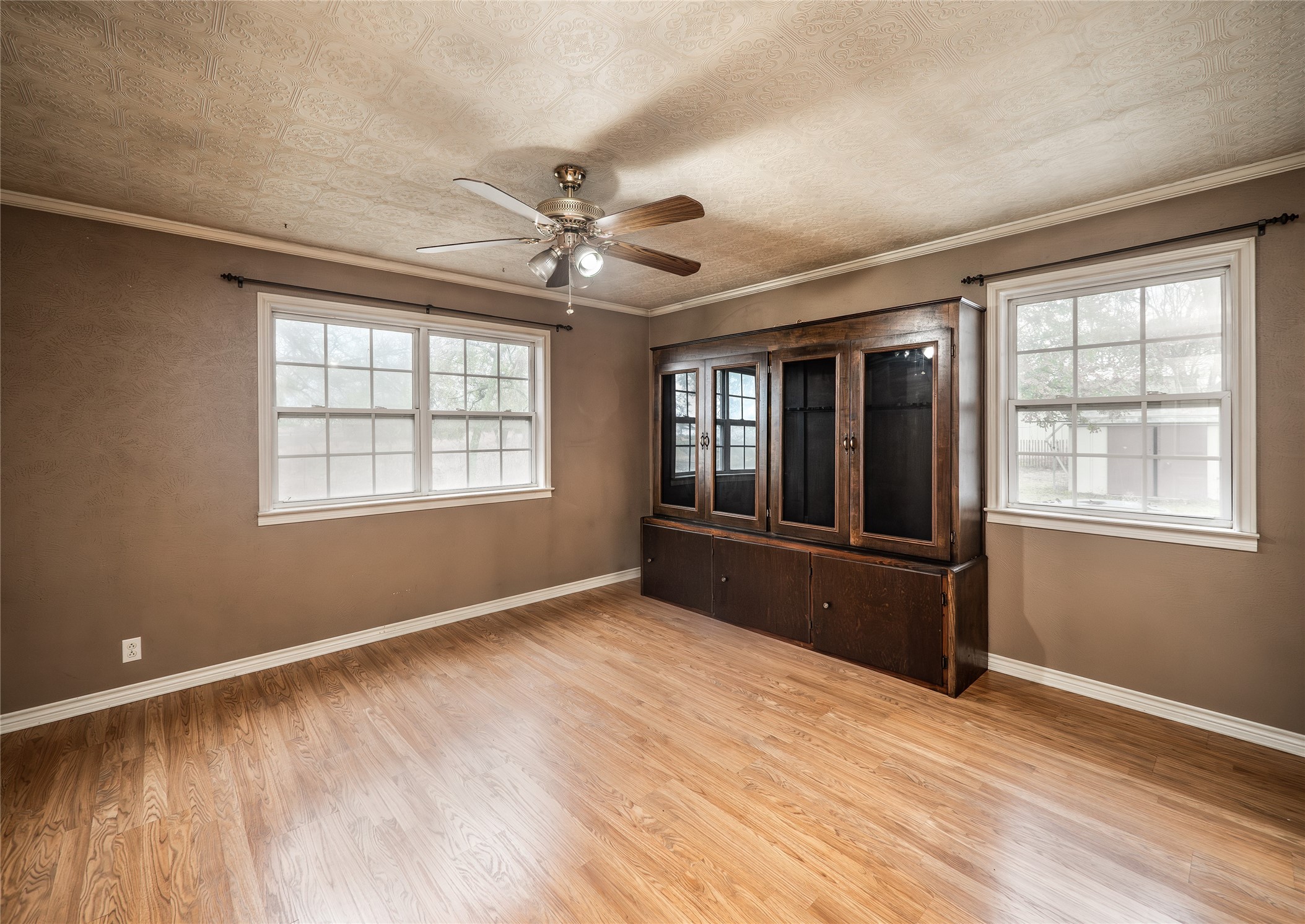 1350 County Road 414 Hamilton, TX 76531 - Photo 22 of 40 a view of an empty room with a window and wooden floor