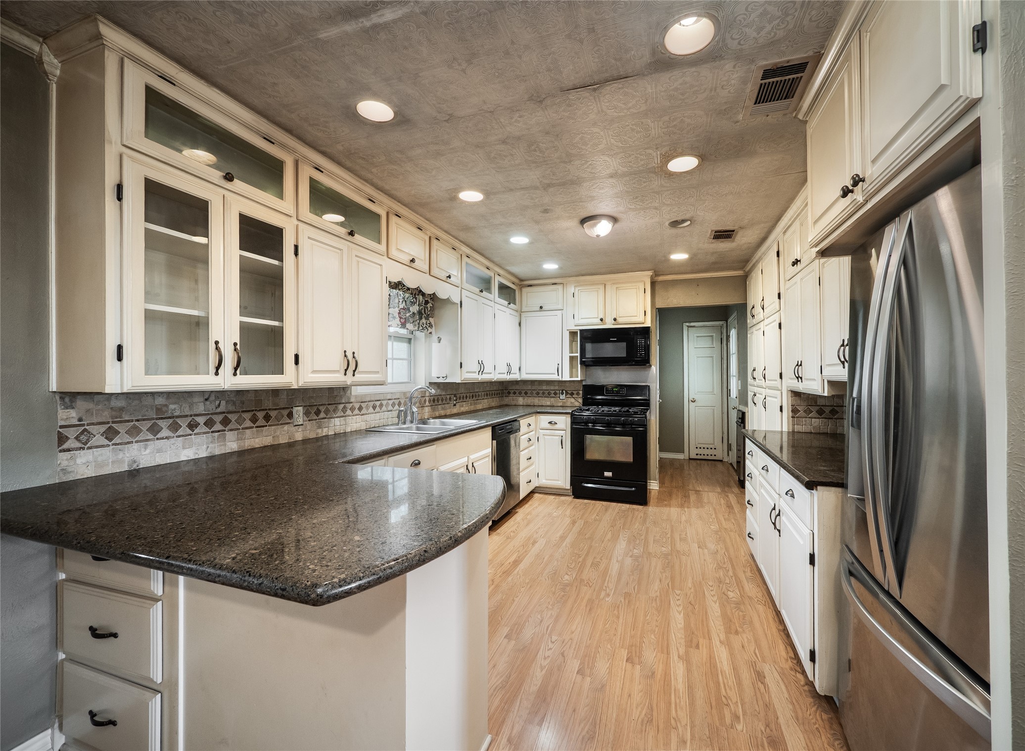 1350 County Road 414 Hamilton, TX 76531 - Photo 7 of 40 a kitchen with stainless steel appliances granite countertop a sink and a stove