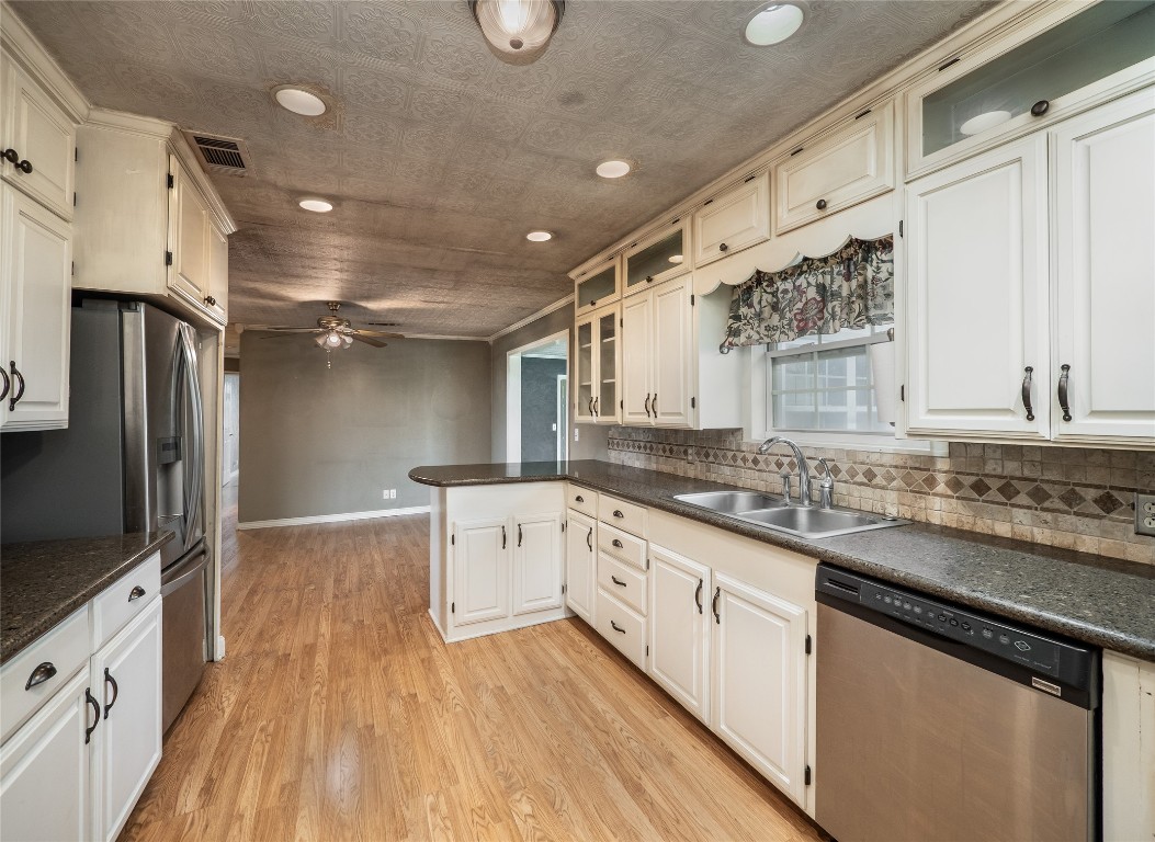 1350 County Road 414 Hamilton, TX 76531 - Photo 9 of 40 a kitchen with granite countertop a sink stove refrigerator and cabinets