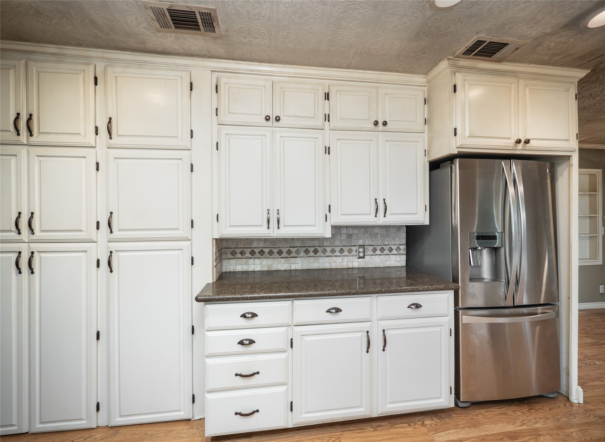 1350 County Road 414 Hamilton, TX 76531 - Photo 10 of 40 a kitchen with white cabinets and refrigerator