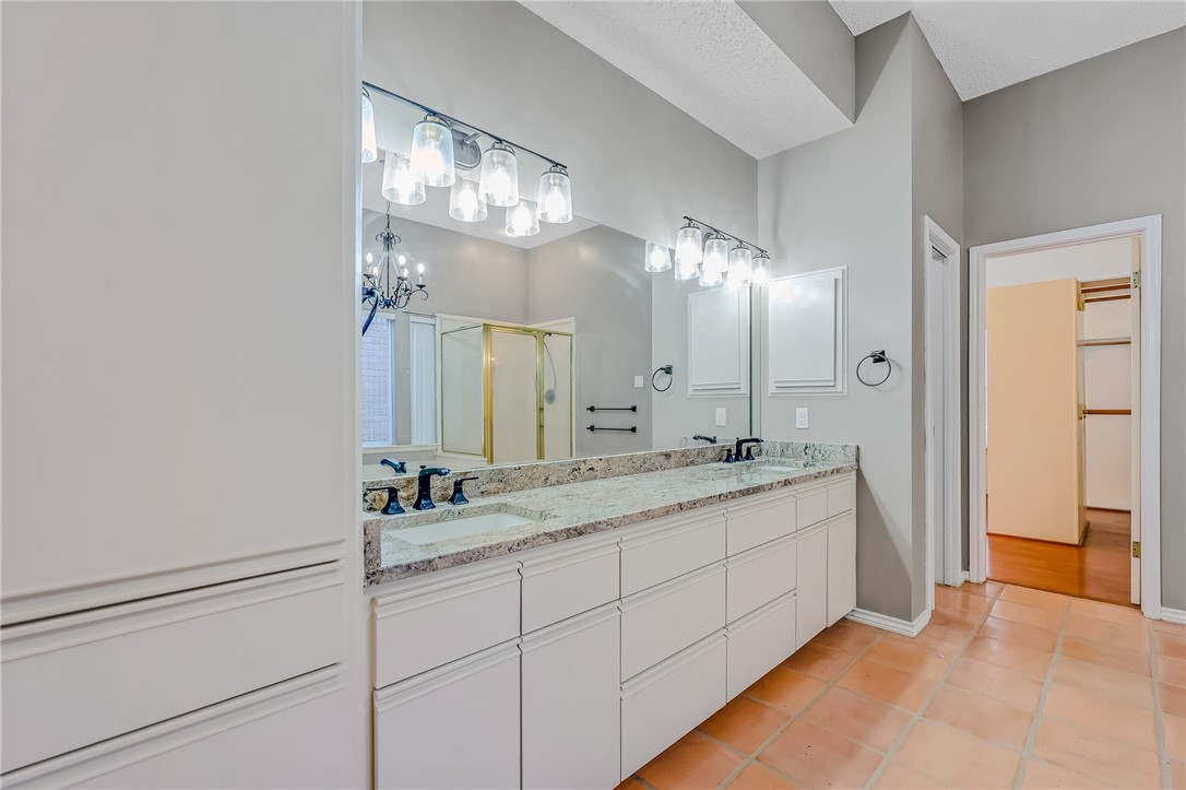 5917 Harvest Hill Road Corpus Christi, TX 78414 - Photo 24 of 40 a bathroom with a double vanity sink and a mirror