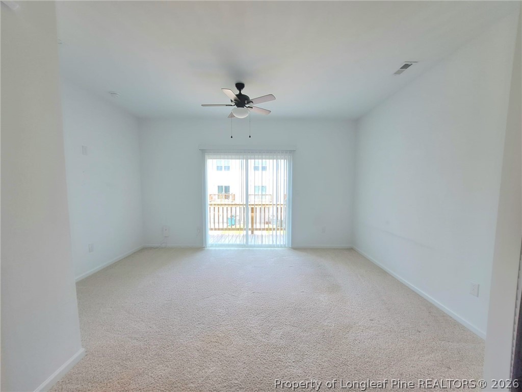 1939 Robin Hill Lane Raleigh, NC 27610 - Photo 6 of 25 an empty room with a chandelier fan and windows