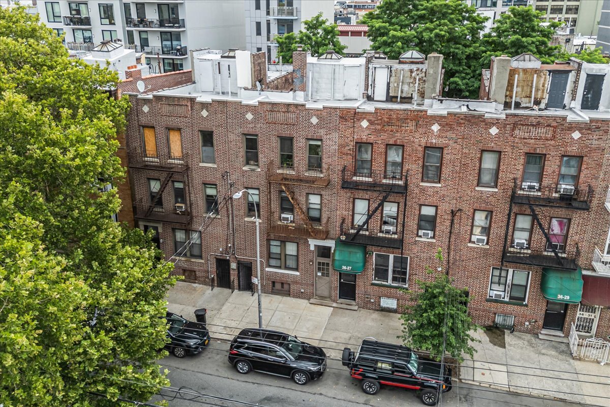 a car parked in front of a brick building