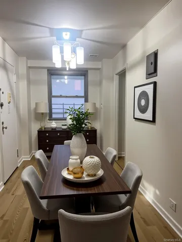 a view of a dining room with furniture and chandelier