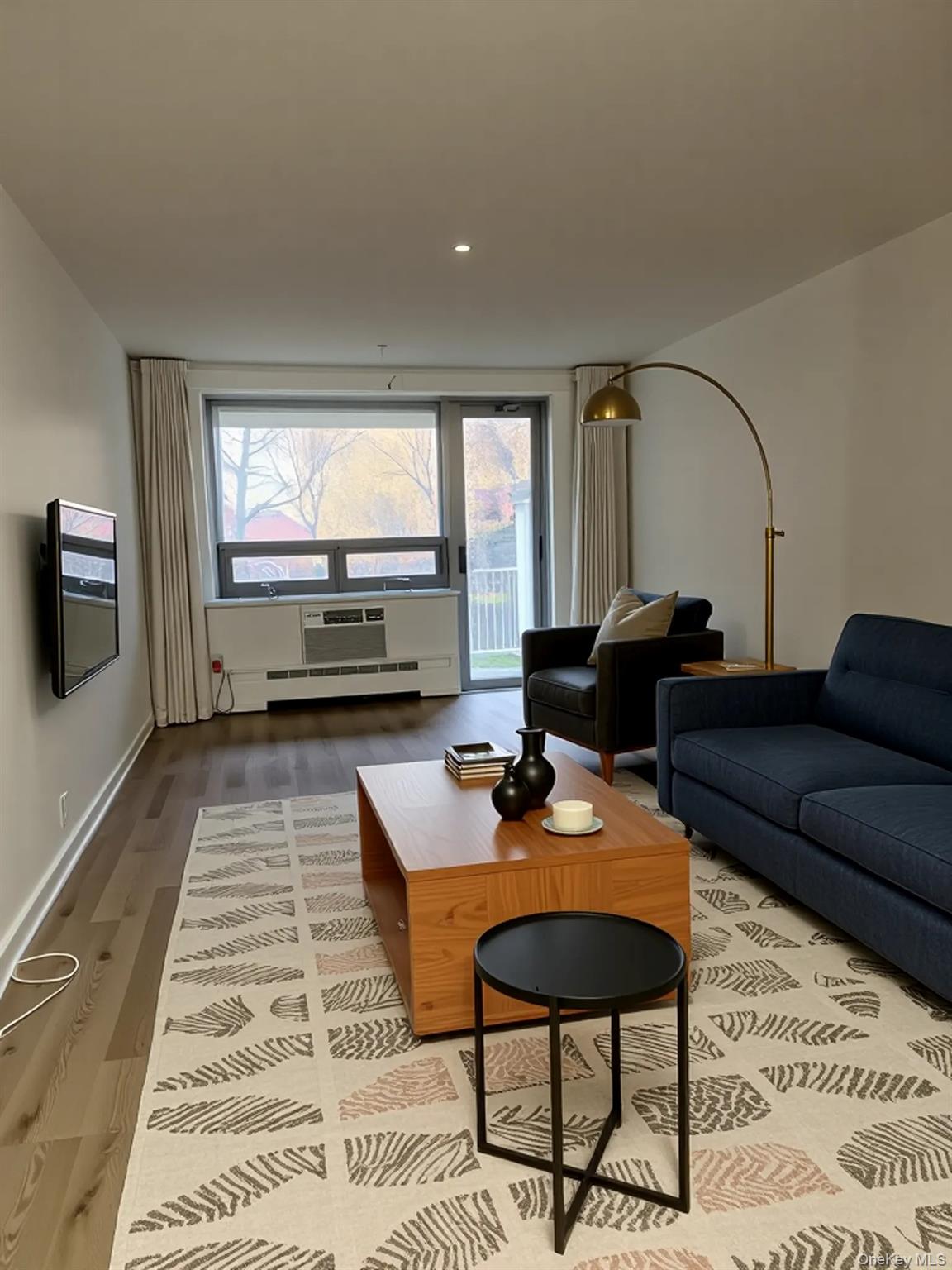 61-25 97th Street, Unit 1D Queens, NY 11374 - Photo 7 of 14 Living area with wood finished floors, a baseboard radiator, recessed lighting, and a wall unit AC