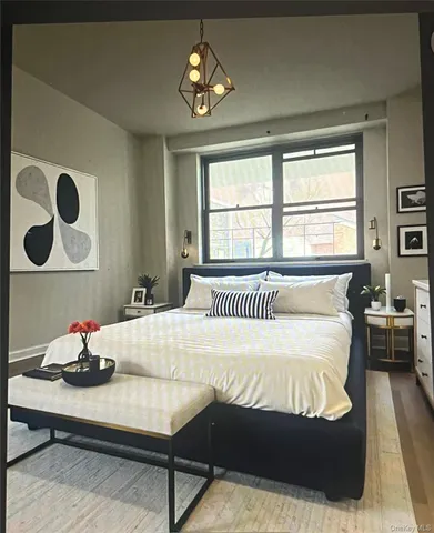 a bedroom with a bed and a chandelier