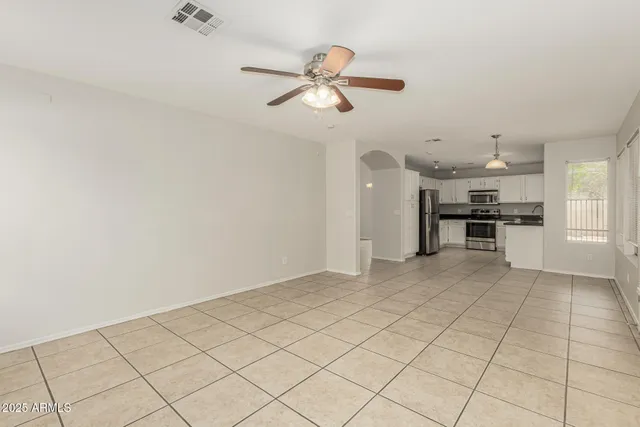 a kitchen with granite countertop white cabinets sink and stainless steel appliances