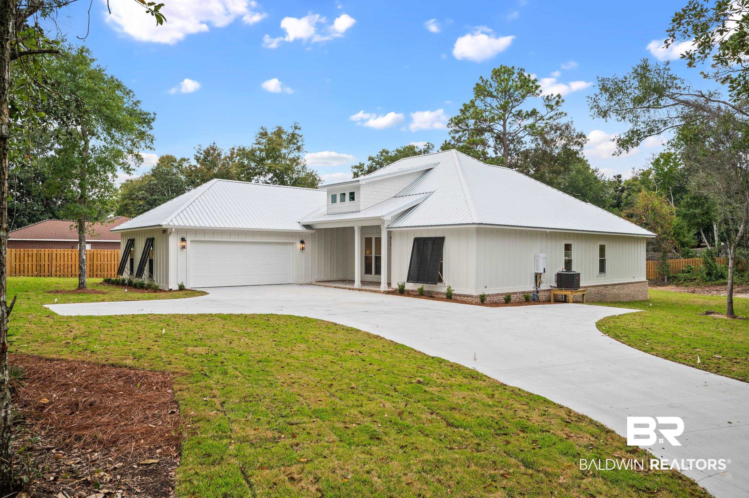 28889 Canal Road Orange Beach, AL 36561 - Photo 4 of 55 Modern farmhouse featuring central AC, a garage, and a front lawn