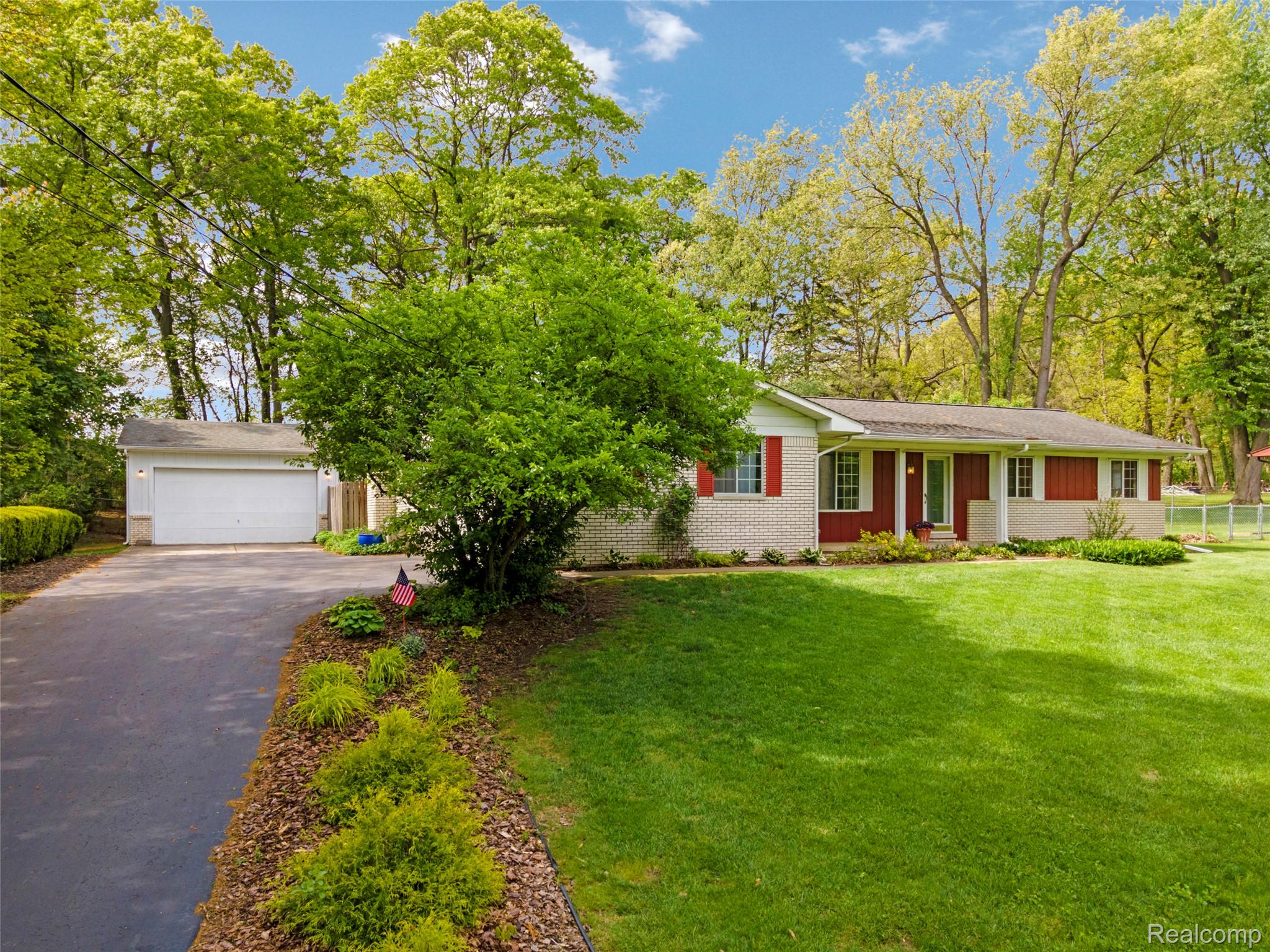 8887 Clark Road Clarkston, MI 48346 - Photo 2 of 40 Single story home featuring brick siding, asphalt driveway, and a front lawn