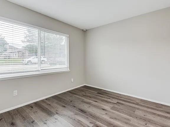 7125 Sorcey Road Dallas, TX 75249 - Photo 6 of 10 Empty room featuring wood finished floors and baseboards