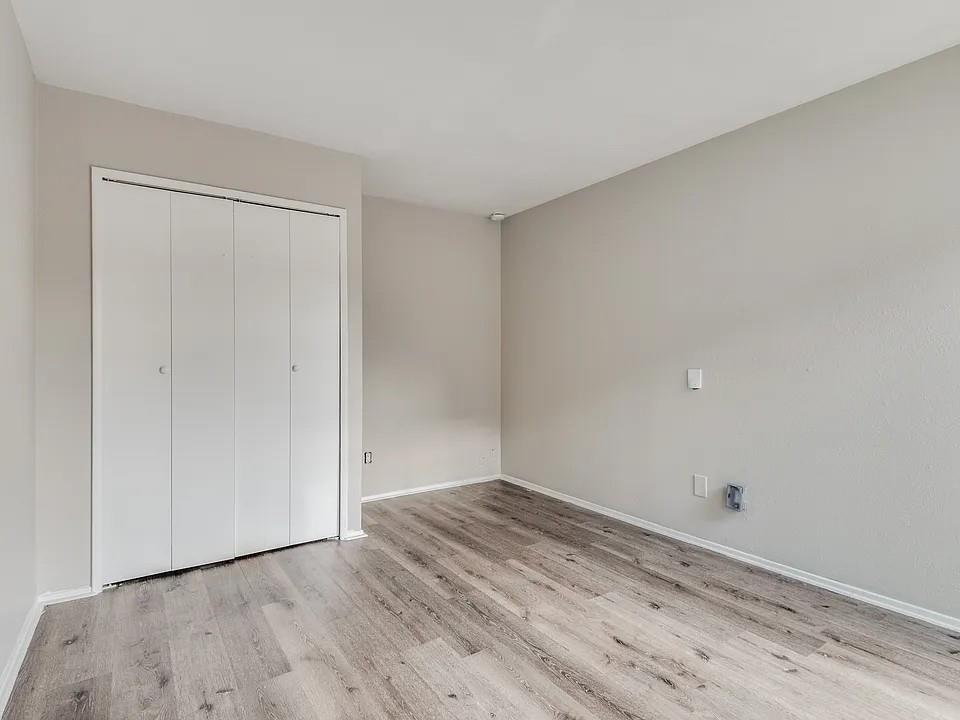 7125 Sorcey Road Dallas, TX 75249 - Photo 7 of 10 Unfurnished bedroom featuring a closet and light wood-style floors