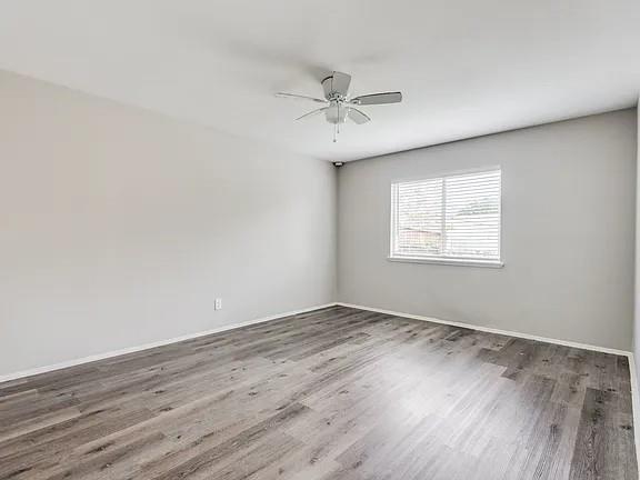 7125 Sorcey Road Dallas, TX 75249 - Photo 9 of 10 Unfurnished room featuring wood finished floors and ceiling fan