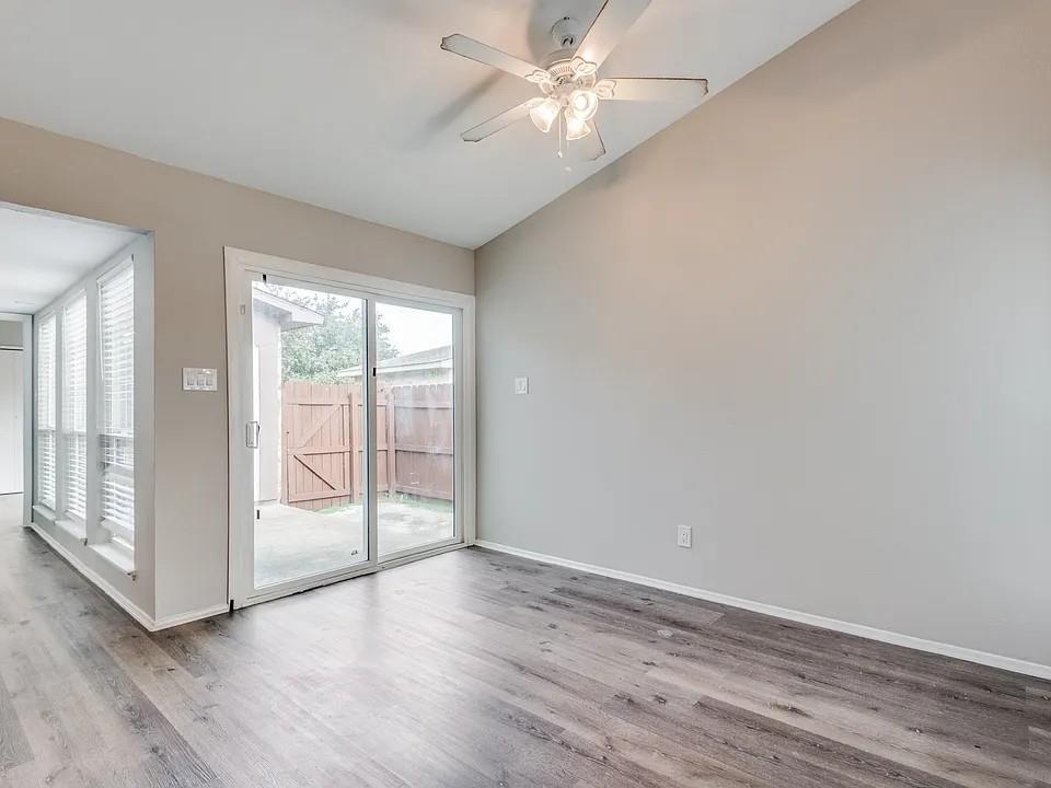 7125 Sorcey Road Dallas, TX 75249 - Photo 10 of 10 Unfurnished room with a ceiling fan, wood finished floors, and lofted ceiling
