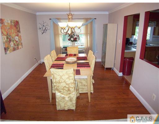 9 Glendale Road Colonia, NJ 07067 - Photo 5 of 19 a view of a dining room with furniture a chandelier and wooden floor