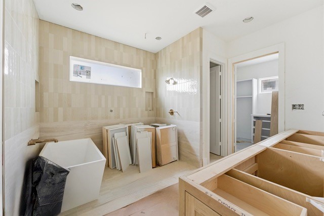 1106 Robbie Street Houston, TX 77009 - Photo 11 of 36 Large primary bathroom with walk-in shower and soaking tub.